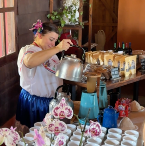 a woman pouring coffee into a Costa Rican coffee maker